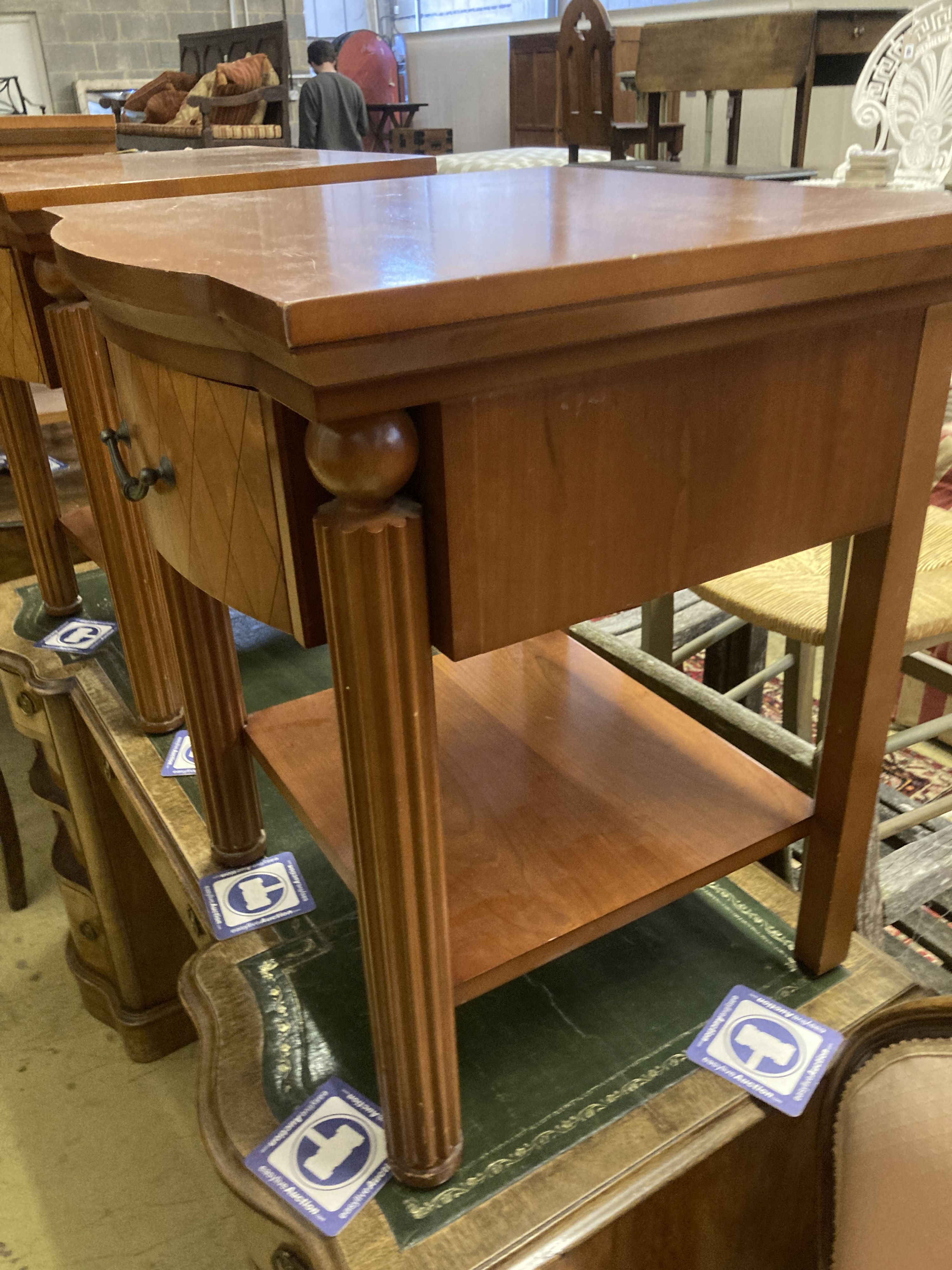 A pair of walnut bowfront two tier bedside tables, width 50cm, depth 50cm, height 61cm